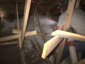 attic installation of loose-fill fiberglass